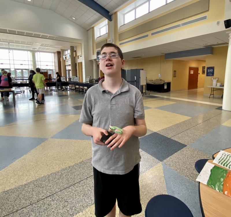 Student Rhys Powell holds the sculpture he created.